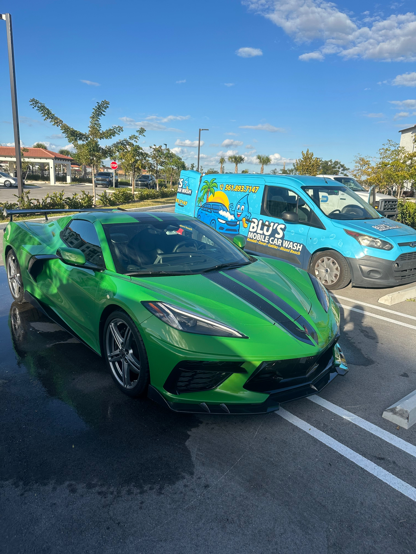 Bright green Chevrolet Corvette C8 next to BLU'S van