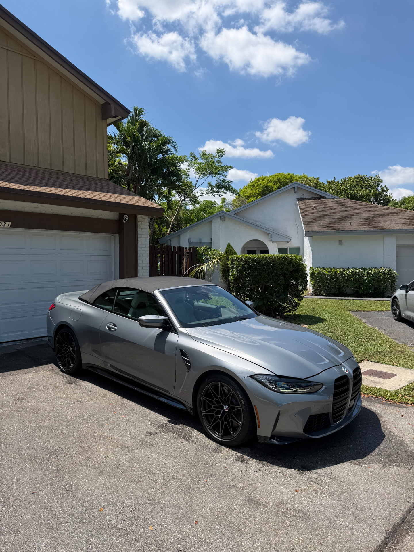 Silver BMW M4 convertible freshly detailed in the driveway