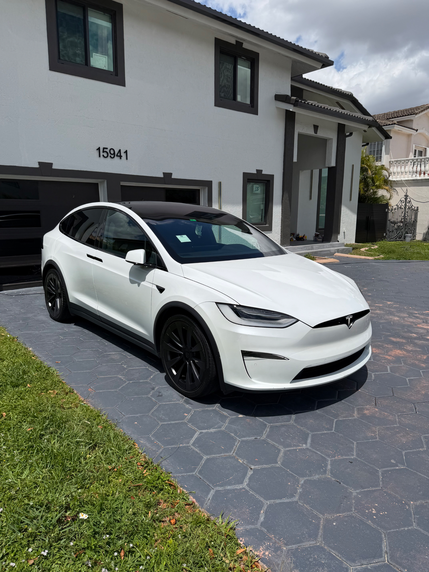 White Tesla Model X detailed in a Miami driveway