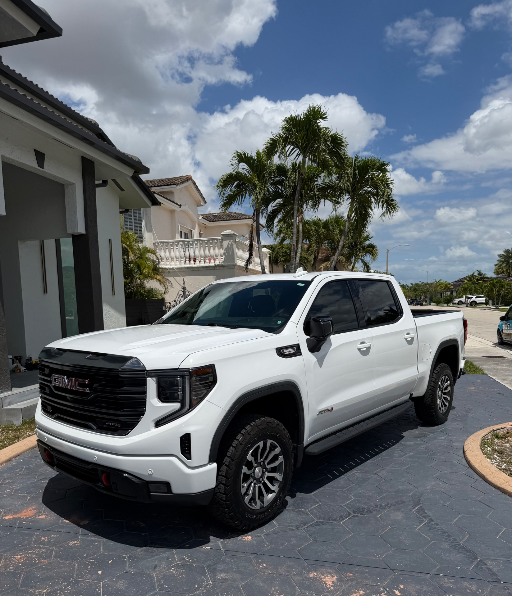 White GMC Sierra AT4 freshly detailed in the driveway